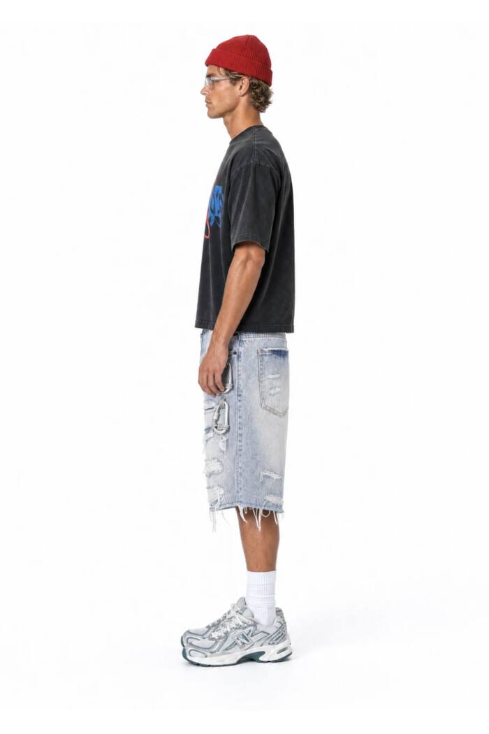 The same shorts seen from the side on a model against a white studio background, showing how the leg falls.